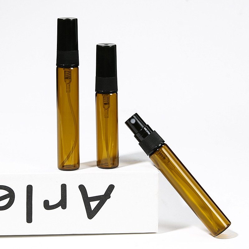 Amber Glass Atomizers Standing on Book