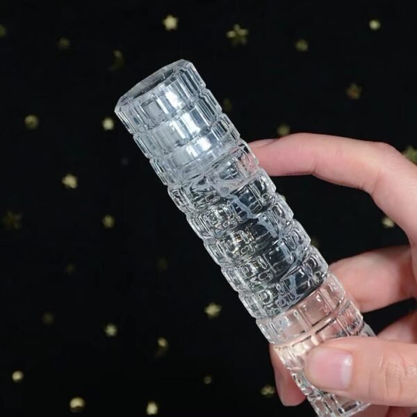 Bamboo Texture Glass Bottle in Hand Starry Background