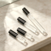 Clear Travel Spray Bottles on Marble Countertop