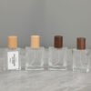 Four Glass Perfume Bottles Beech and Dark Wood Caps