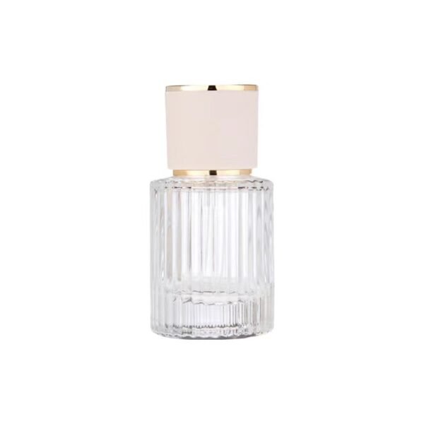 Ribbed Clear Glass Perfume Bottle White Gold Cap White Background