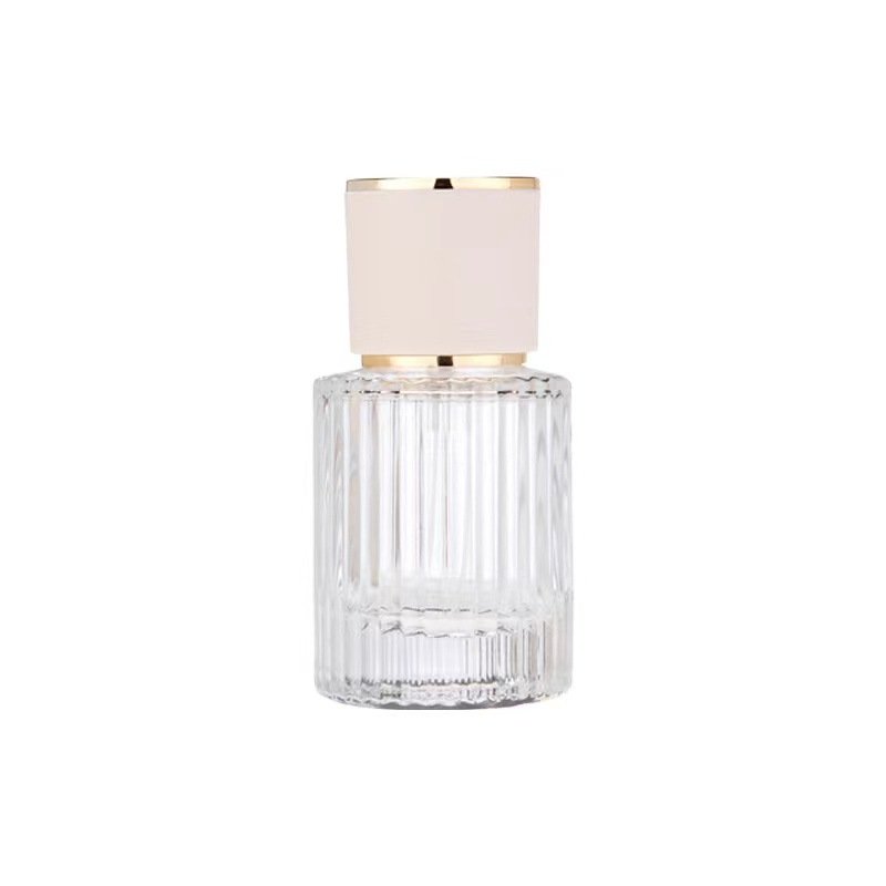 Ribbed Clear Glass Perfume Bottle White Gold Cap White Background