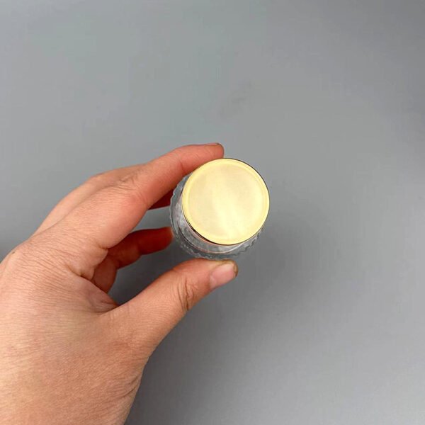 Gold Cap Top View in Hand
