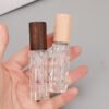 Embossed Glass Bottles Walnut and Beech Caps in Hand