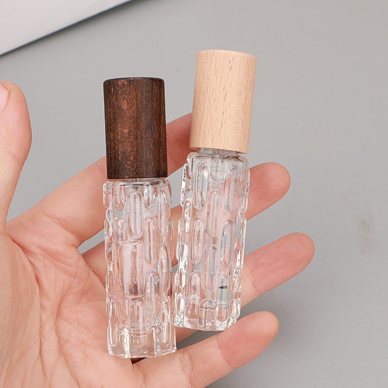 Embossed Glass Bottles Walnut and Beech Caps in Hand